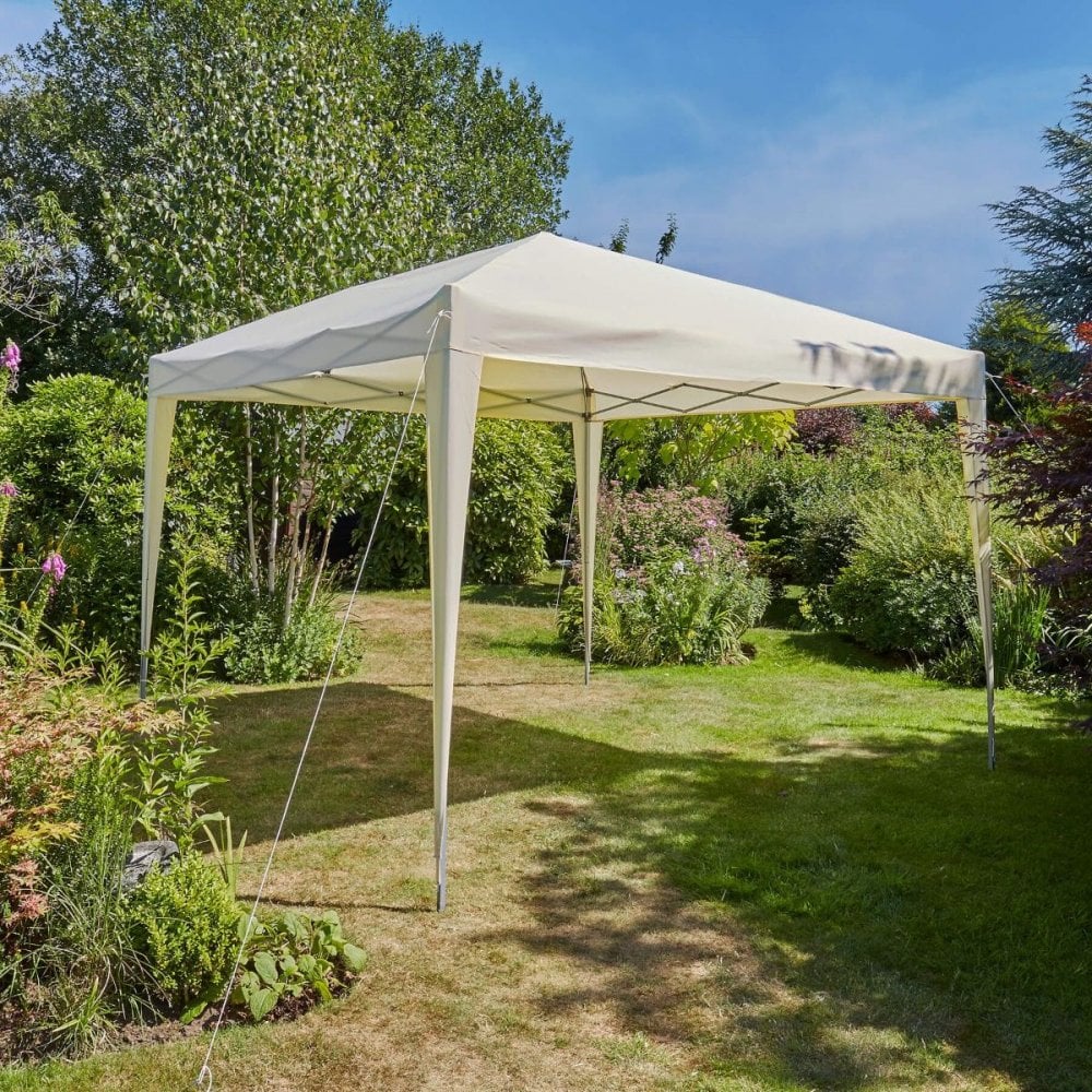 A white pop-up gazebo on a green lawn, on a sunny day