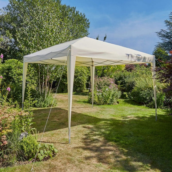 A white pop-up gazebo on a green lawn, on a sunny day