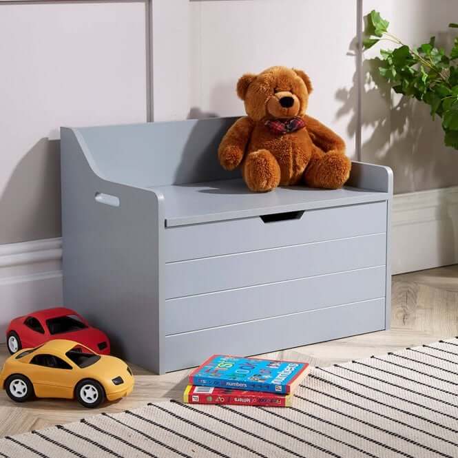 a grey toy storage box with toys outside