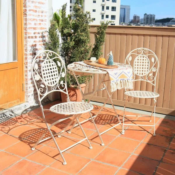a white bistro set on a patio