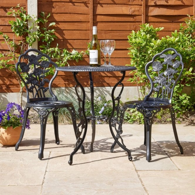 a black bistro set in a yard
